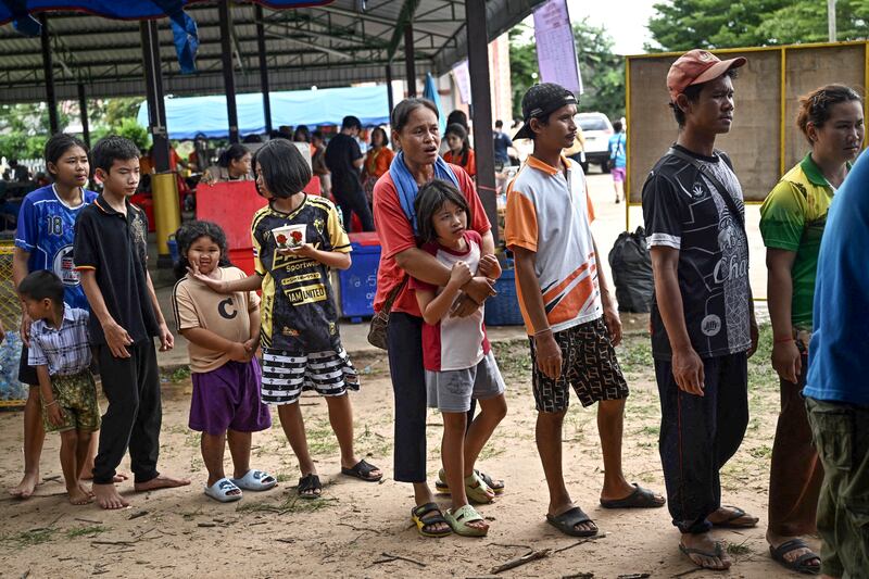 Evacuees displaced by the ongoing conflict between Thailand and Cambodia line up for food at a makeshift evacuation center inside a Buddhist temple in the Thai border province of Sisaket, Thailand, July 26, 2025.