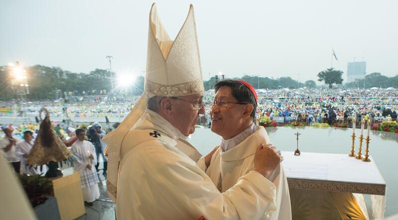 Pope Francis greets Cardinal Luis Antonio Tagle at Rizal Park, in Manila, Philippines, Jan. 18, 2015.