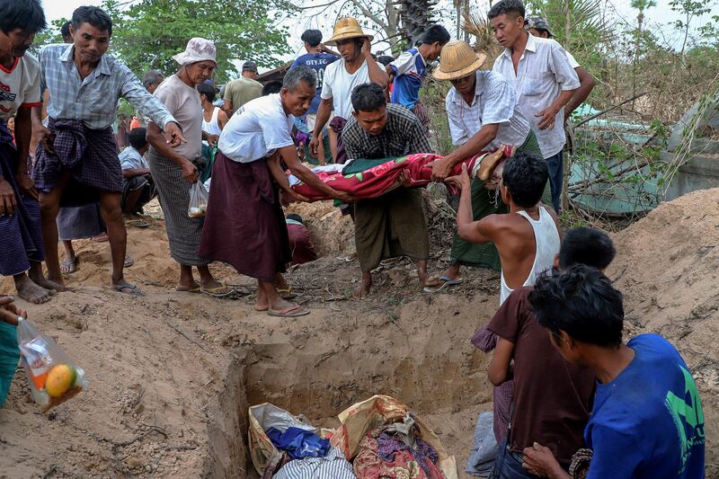 Bodies are buried after a school was destroyed by a junta bombing at Oe Htein Kwin village in Tabayin township in Sagaing, May 12, 2025.