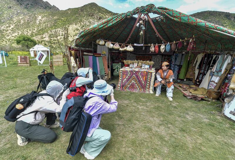 Tourists take photos at the Nomadic Culture Tourism Festival on June 15, 2024 in Urumqi, Xinjiang Uyghur Autonomous Region of China.