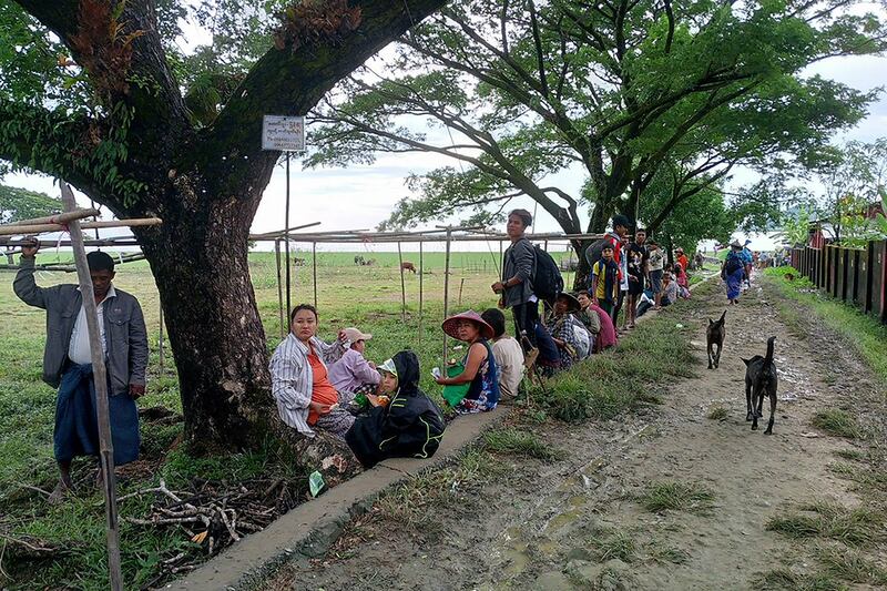 People flee from a village after fighting between Myanmar's military and the Arakan Army in Pauktaw township in western Rakhine state on Nov. 19, 2023.