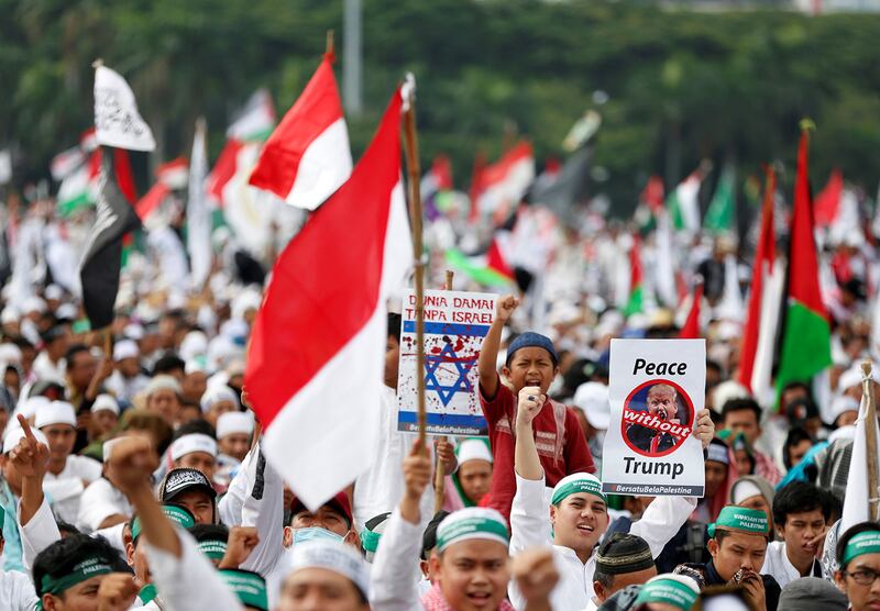 Protesters wave Palestinian and Indonesian flags during a rally to condemn then-U.S. President Donald Trump’s decision to recognize Jerusalem as Israel’s capital, at Monas, the national monument, in Jakarta, Dec. 17, 2017.