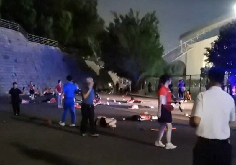 Injured people lie on the road after a car rammed into them outside a sports center in Zuhai, Guandong province, China, Nov. 11, 2024.