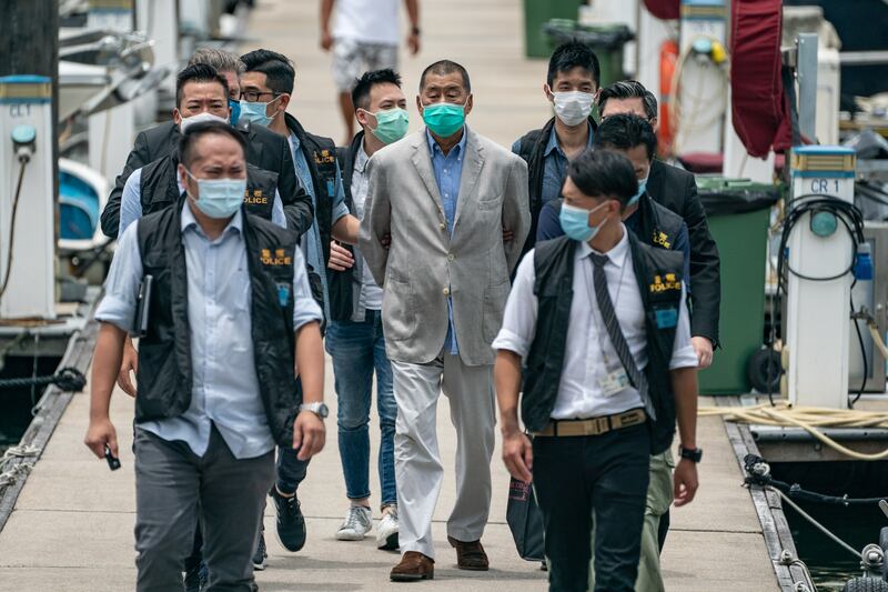 Hong Kong media tycoon and Apple Daily founder Jimmy Lai is escorted by the police for evidence collection on Aug. 11, 2020 in Hong Kong.