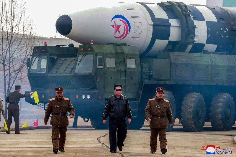 This image distributed by the North Korean government on March 24, 2022, and not independently verifiable shows leader Kim Jong Un walking away from what state media reports as a "new type" of intercontinental ballistic missile.
