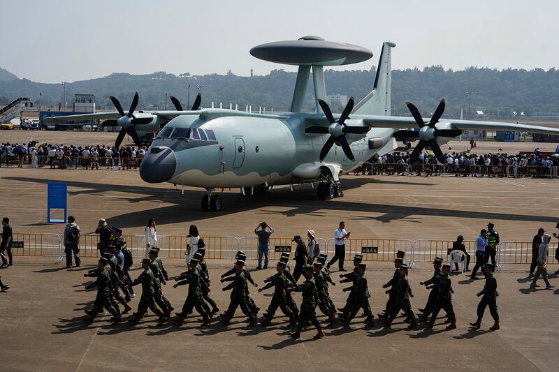 Chinese soldiers march past the Chinese KJ-500A AWACS airplane displayed at Airshow China 2024 at Zhuhai in China's Guangdong province on Nov. 12, 2024.